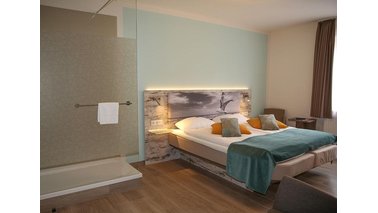 Ein Doppelzimmer des City-Hotel-Bremerhaven mit Bett und Dusche 